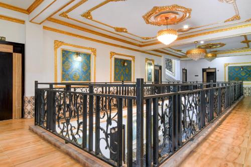 an ornate staircase in a home with a wrought iron railing at SPOT ON The Green Palace in Lālbāgh