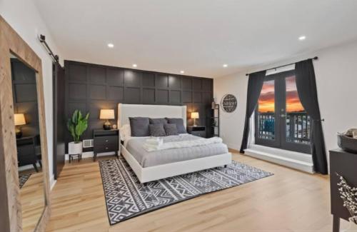 a large bedroom with a white bed and a rug at 3BR Stylish Retreat, Minutes from Downtown Pittsburgh, Free 3-Car Parking in Pittsburgh