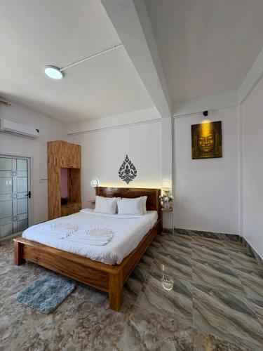 a bedroom with a large bed in a room at Por Chey Residence in Battambang