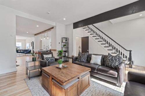 a living room with a couch and a table at 3BR Stylish Retreat, Minutes from Downtown Pittsburgh, Free 3-Car Parking in Pittsburgh
