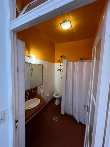a bathroom with a white sink and a toilet at Casa Próspera in Buenos Aires