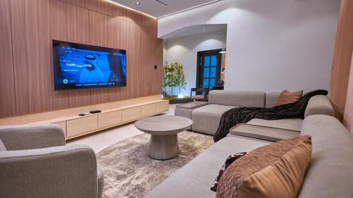 a living room with a couch and a flat screen tv at Jeffreys Apartments in Lagos