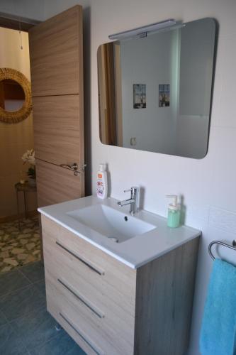 a bathroom with a sink and a mirror at Casa Flor de Almendro 