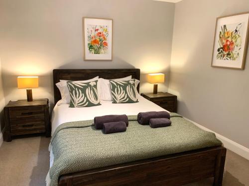 a bedroom with a large bed with two lamps at The Old Bakery - Luxury Three Bed House with Roof Terrace in Whitby