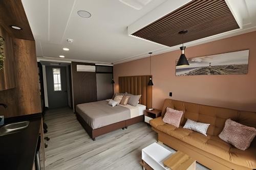 a hotel room with a bed and a couch at Epic Suite 210 Deluxe Aeropuerto in Cuba