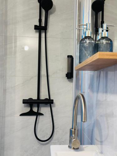 a bathroom with a faucet and a sink at Le Cherry - Plein centre Rheu in Le Rheu