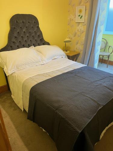 a bedroom with a large bed with a large headboard at Hikers Rest in Findon
