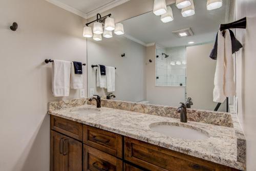 a bathroom with two sinks and a large mirror at Lakes View at Hound Ears in Valle Crucis