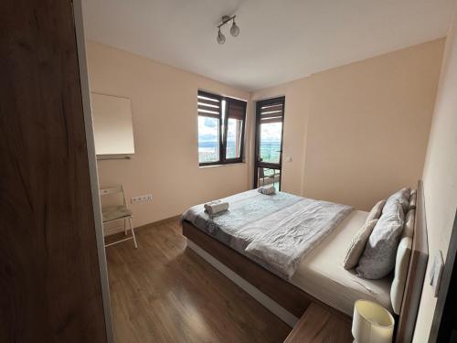 a bedroom with a large bed and a window at Breathtaking sea view apartment in Varna City