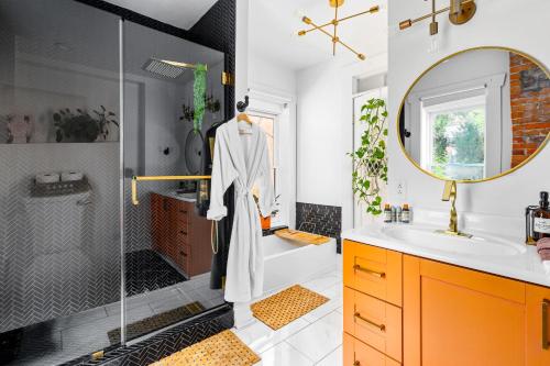 a bathroom with a shower and a sink and a mirror at Prime Location Top Rated Clean Parking Free! in Columbus