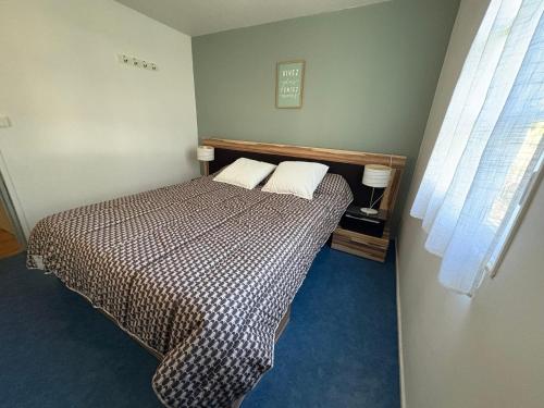 a bedroom with a bed with two pillows on it at Chalet Proche mer in Latour-Bas-Elne