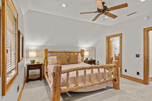Un dormitorio con una cama de madera y un ventilador de techo. en Creekside Hideaway at The Farm, en Banner Elk