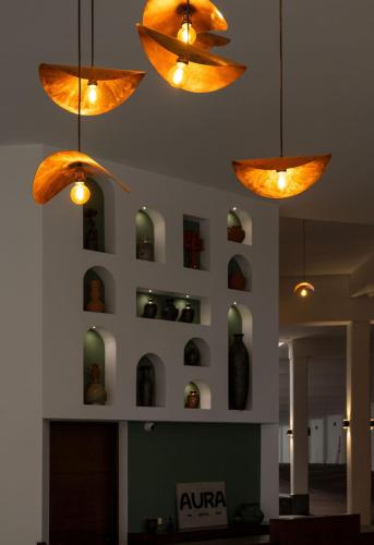 a room with some bottles on a wall with lights at Aura Hotel in Uruapan del Progreso