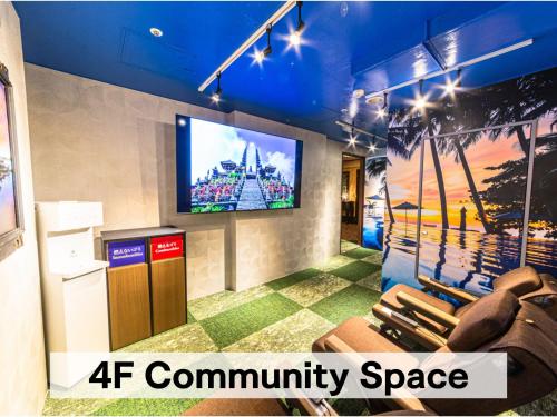 a living room with a tv on a wall at Hotel Balian Resort Chiba - Family Kids Group Concept in Chiba