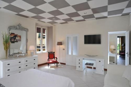a bedroom with a bed and a desk and a tv at Trattoria Laghee con alloggio in Cernobbio