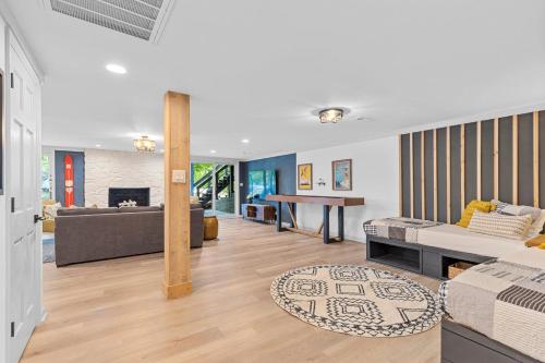 a living room with a couch and a table at Niblick on Norman w/Heated Pool & Optional Boat Rental in Cornelius