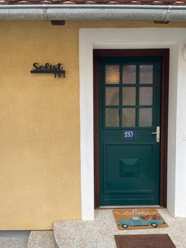 a green door on the side of a building at Terme Čatež apartma Solist 