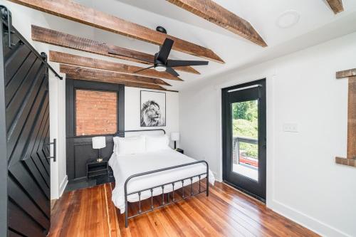 a bedroom with a bed and a ceiling fan at Uprising A pet friendly couples retreat in Lynchburg