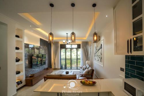 a living room with a couch and a table at Lakeside Serenity Stylish 2BR Getaway - Entebbe in Entebbe