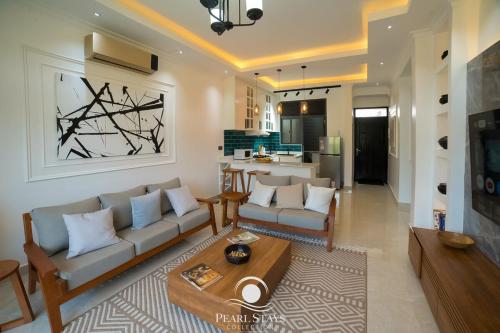 a living room with a couch and a table at Lakeside Serenity Stylish 2BR Getaway - Entebbe in Entebbe