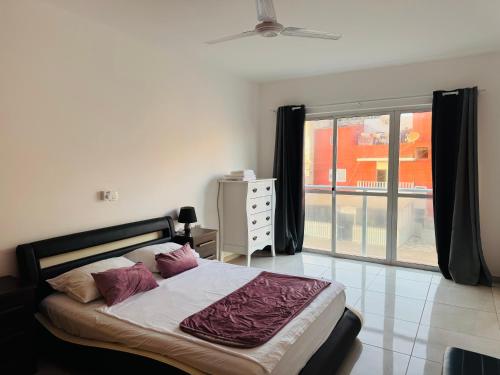 a bedroom with a bed and a large window at Apartamentos Ramos 3 in Santa Maria