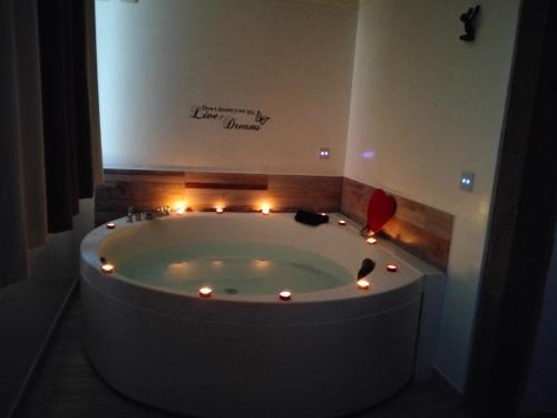 a bathroom with a tub with lights in it at La casa nel Borgo Sospeso "con vasca "no idro " e vista panoramica" in Vitorchiano