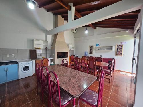 a kitchen and dining room with a table and chairs at MH Hostel in Encarnación