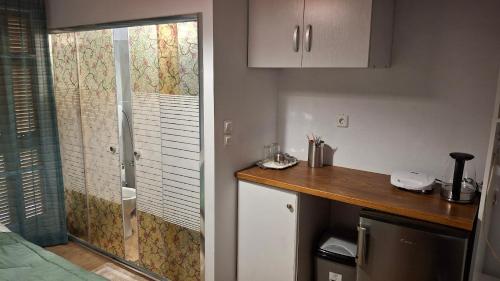a kitchen with a shower and a wooden counter top at Nafpaktos Happy town studio in port in Nafpaktos