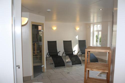 a group of chairs sitting in a room at Romantik Hotel Aquarium in Friedrichstadt