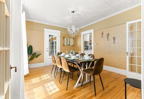 a dining room with a table and chairs at Spacious 8 bed stay - HOT TUB, Patio, fireplace, 3 full bathrooms private home in Moncton in Moncton