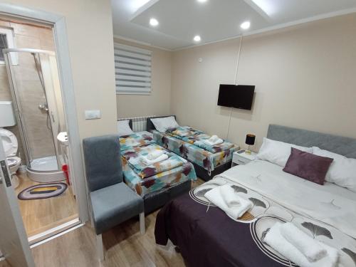a hotel room with a bed and a bathroom at Apartments & Rooms -MDL Lazić in Belgrade