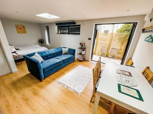 a living room with a couch and a table at Modern Self Contained Garden Annexe Sleeps up to 4 in Forest Hill