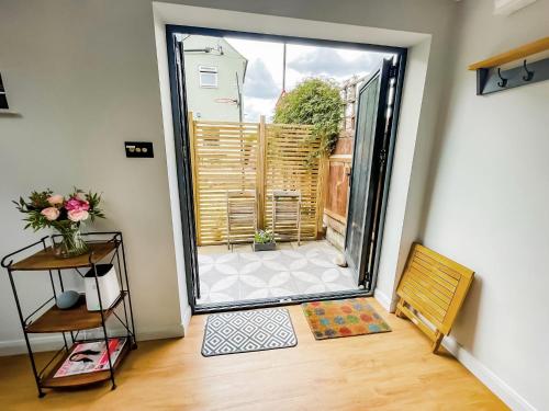 a room with a door open to a patio at Modern Self Contained Garden Annexe Sleeps up to 4 in Forest Hill