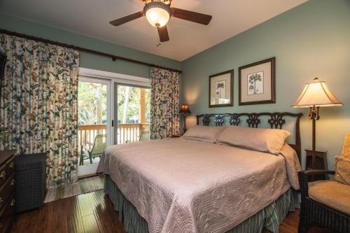 a bedroom with a bed and a window at 335 Palmetto Walk - Locke Nest III in Edisto Island