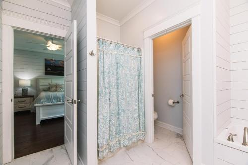 a bathroom with a door leading to a bedroom at A Pura Vida in Edisto Island