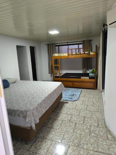a bedroom with a bed and a bunk bed at Apartamento Central in Primavera do Leste