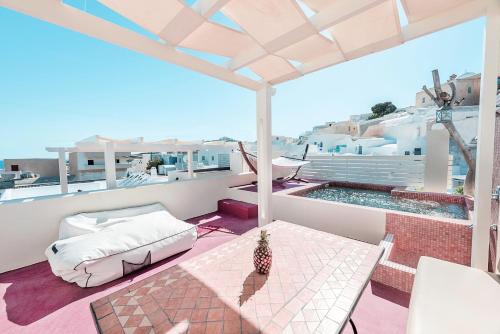a balcony with a bed and a table at Luxury Villas Hariton in Emporio