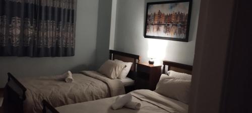 a hotel room with two beds and a window at Alexandra's house in Arta