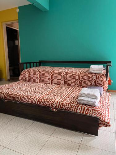 a bed in a room with towels on it at Paihuen in Plottier