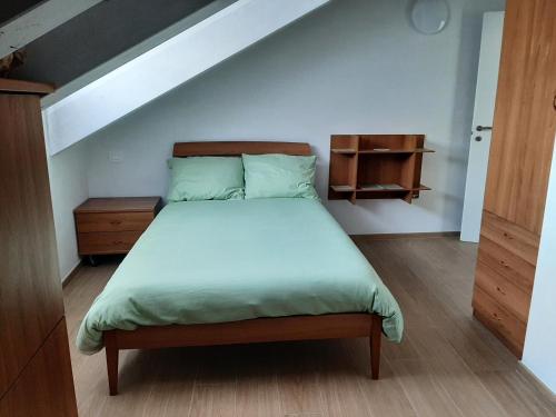 a bedroom with a bed and a wooden floor at La Fenice in Mortara