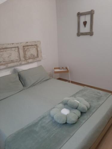 a bed with three blue towels on it at La Fenice in Mortara