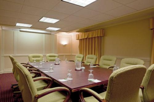 a conference room with a long table and chairs at Boxboro Regency in Boxborough