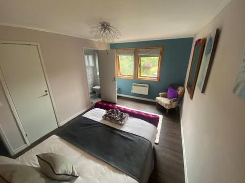 a bedroom with a large bed in a room at Carpenters-stay in Dorking