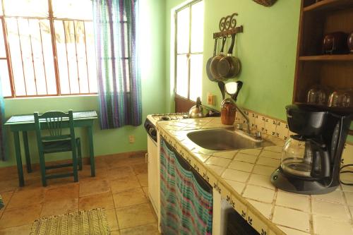 a kitchen with a sink and a counter top at Casa Poesía Sayulita in Sayulita