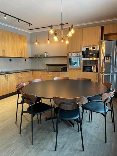 a kitchen with a large wooden table and chairs at High standard apartment, 15 min to Romme Alpin in Borlänge
