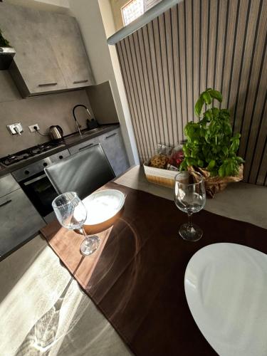 a kitchen with two wine glasses on a counter at Alloggio Turistico in Via Zotti in Lido di Ostia
