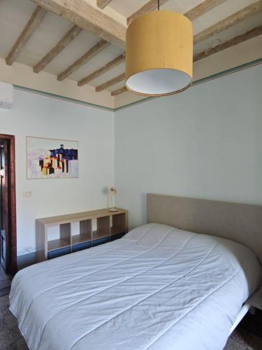 a bedroom with a large white bed in a room at Garibaldi 23 in Arezzo