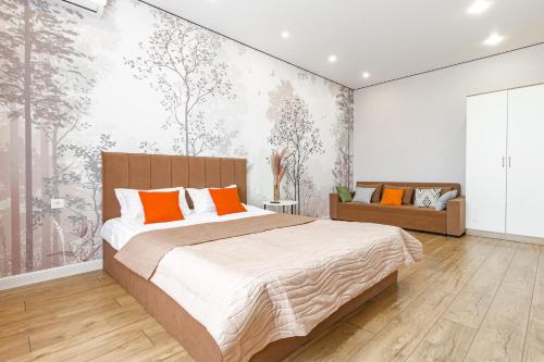 a bedroom with a large bed and a couch at ALMA PARK Apartments 326 in Taldykolʼ