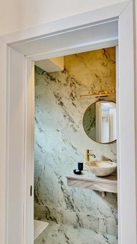 a bathroom with a sink and a mirror at Jolie Boutique Hotel in Craiova