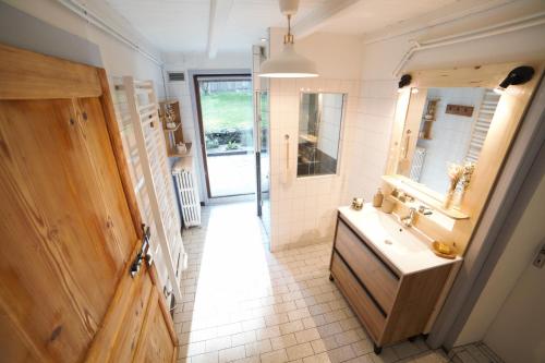 a bathroom with a sink and a mirror at Gite des deux fontaines in Samoëns